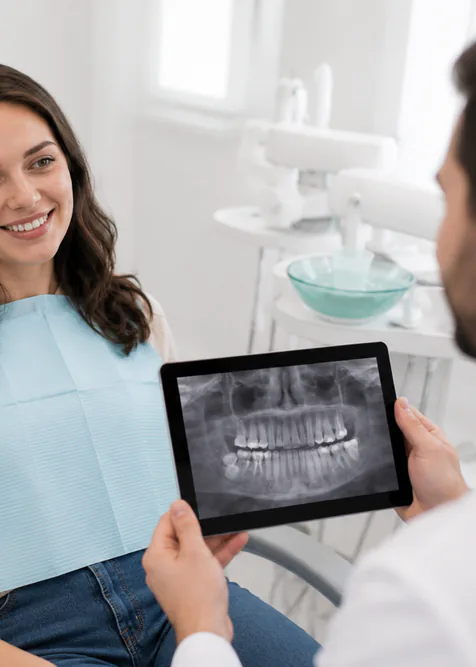 Patient and dentist reviewing a digital dental radiograph in a Toronto TMJ consultation room