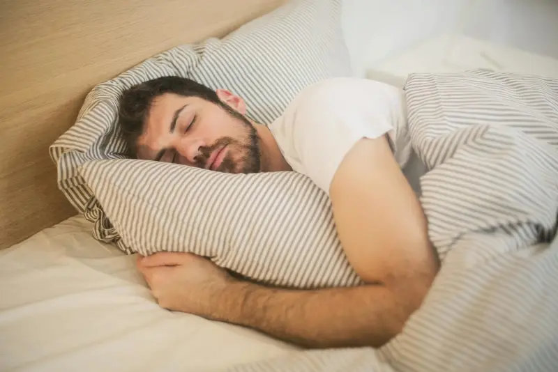 A patient sleeping on her back, illustrating the posture in which jaw position and airway space most commonly interact